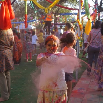 Children celebrating Holi with colored powder at ISKCON Cedar Park
