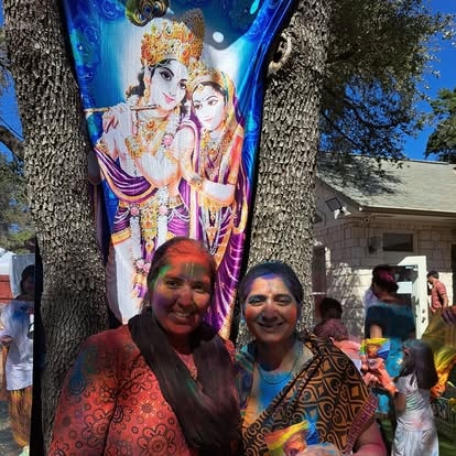 Man placing flower garland on woman at ISKCON Cedar Park