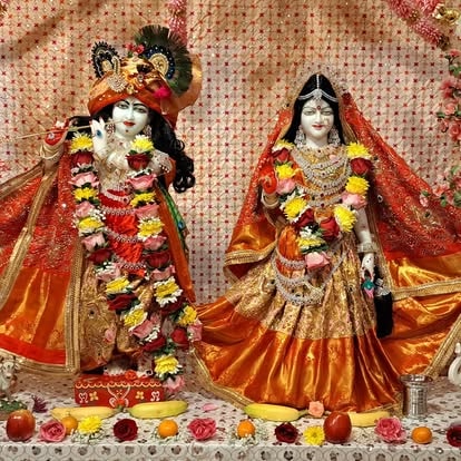 Hindu deity statues adorned with flower garlands at ISKCON Cedar Park